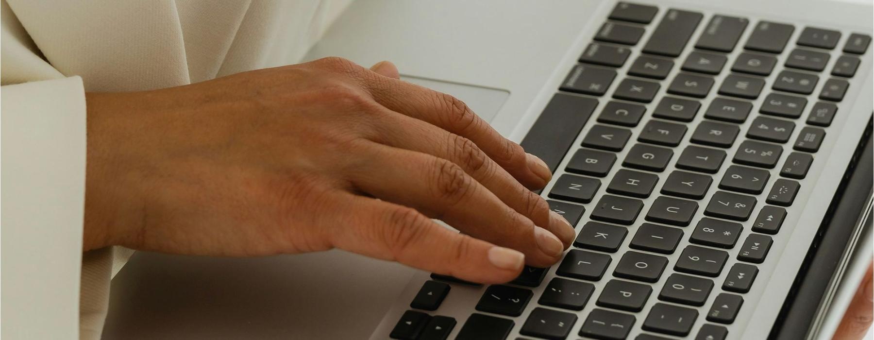 a person typing on a laptop